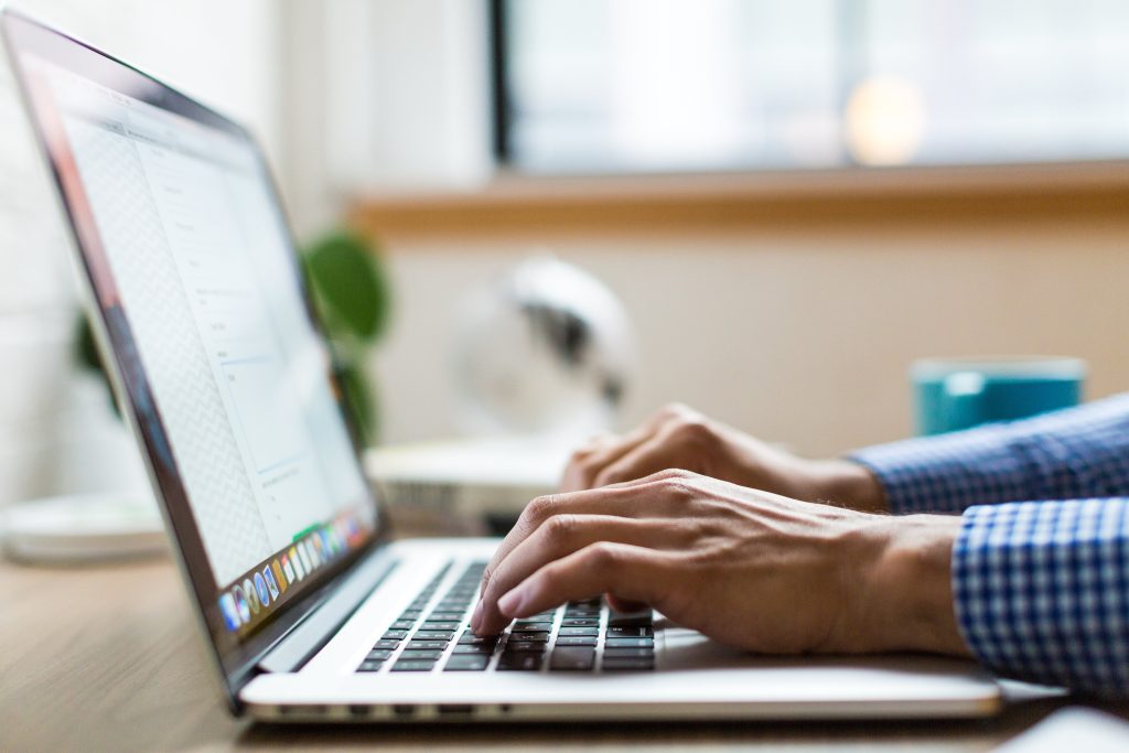 woman typing on laptop at desk
